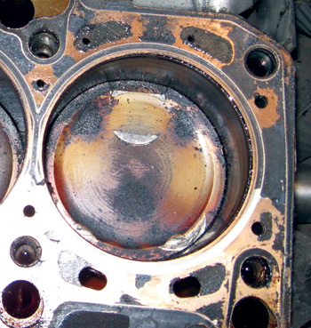 photo 8: this is usually the extent of the damage to the pistons, but deck height should be checked on all cylinders to determine if more severe damage has occurred.