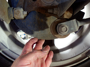 photo 6: a loose or cracked disc brake dust shield will produce a tinny, rattling noise on a gravel-surface road.