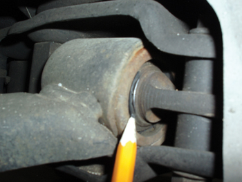 The bright metallic spot on the control arm shaft indicates metal-to-metal contact. 